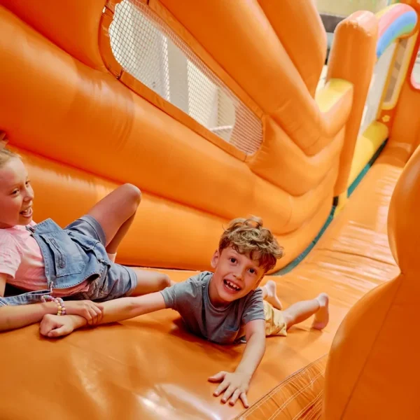 children laughing while playing on an inflatable s 2026 01 08 23 55 16 utc Nero Ocio